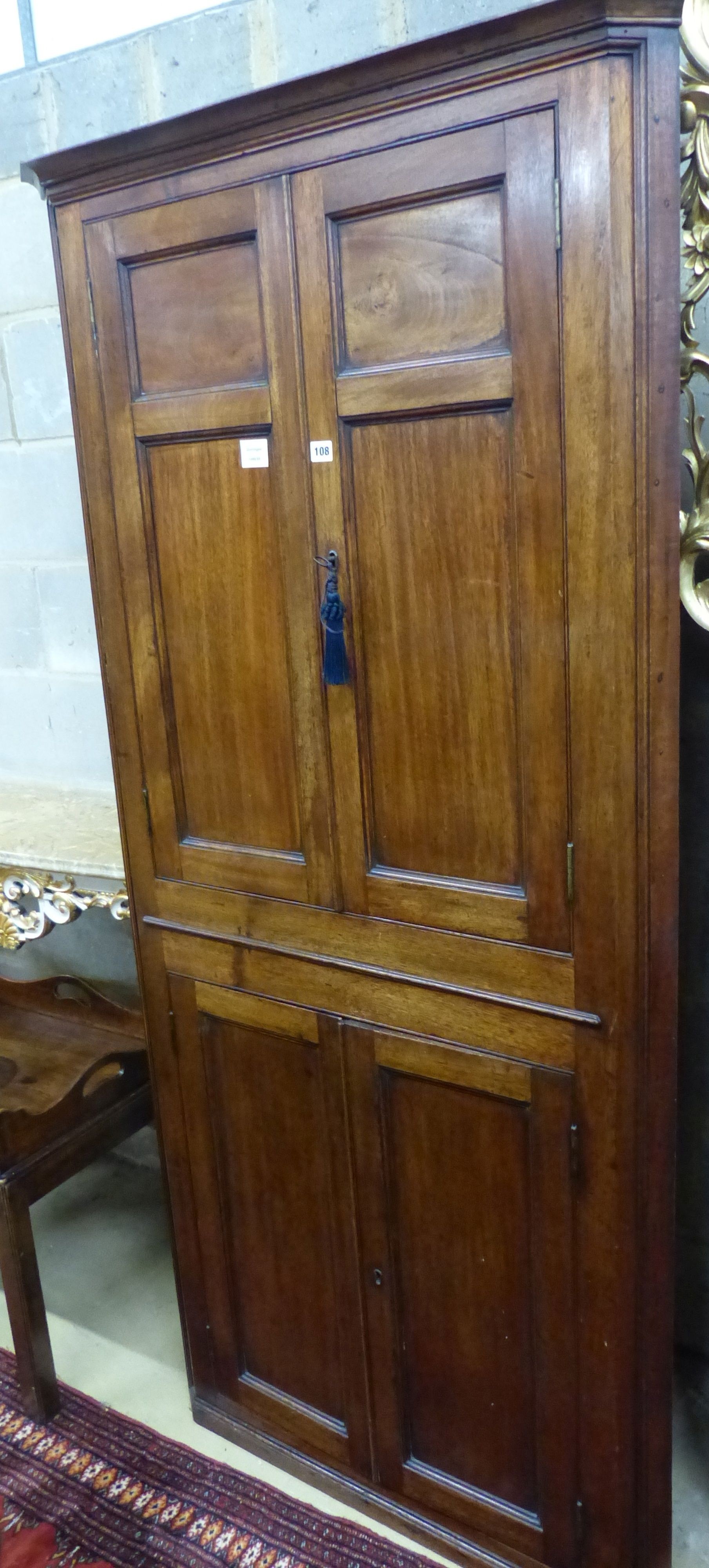 A George III mahogany four door standing corner cabinet, W.90cm D.48cm H.190cm